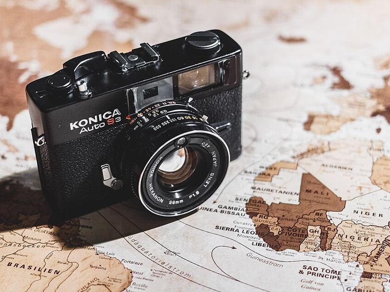 A black Konica film camera on an old map