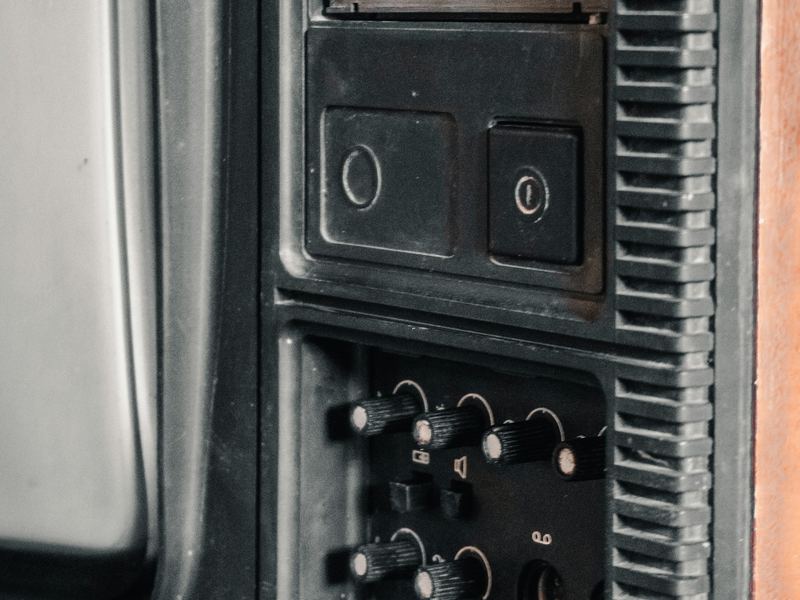 The control panel on the side of a vintage television set
