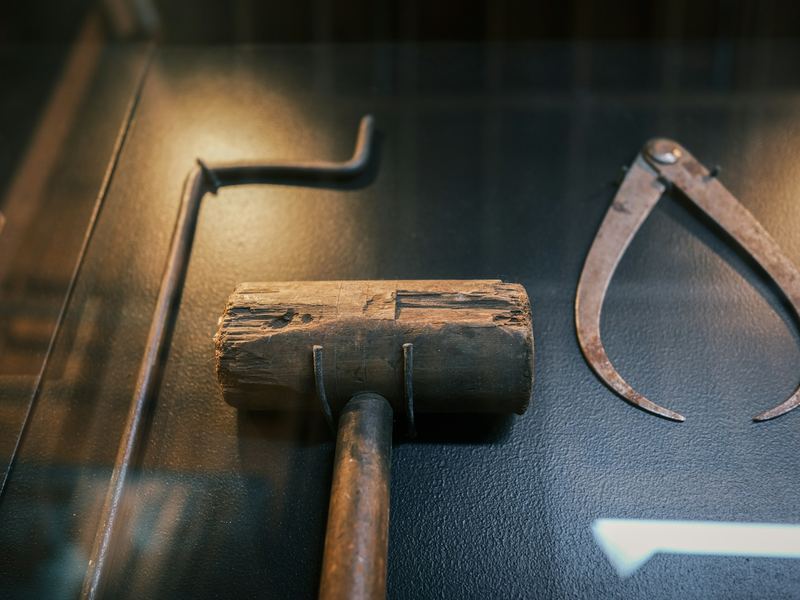 A wooden mallet and a steel caliper on a workbench